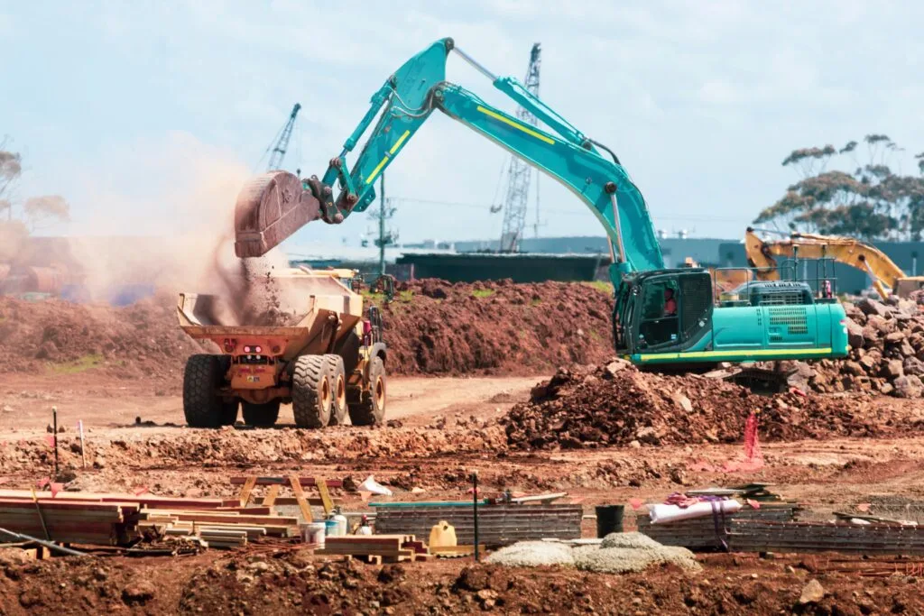 An Excavator loading a truck