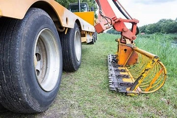 Yellow Frail Mower in green grass